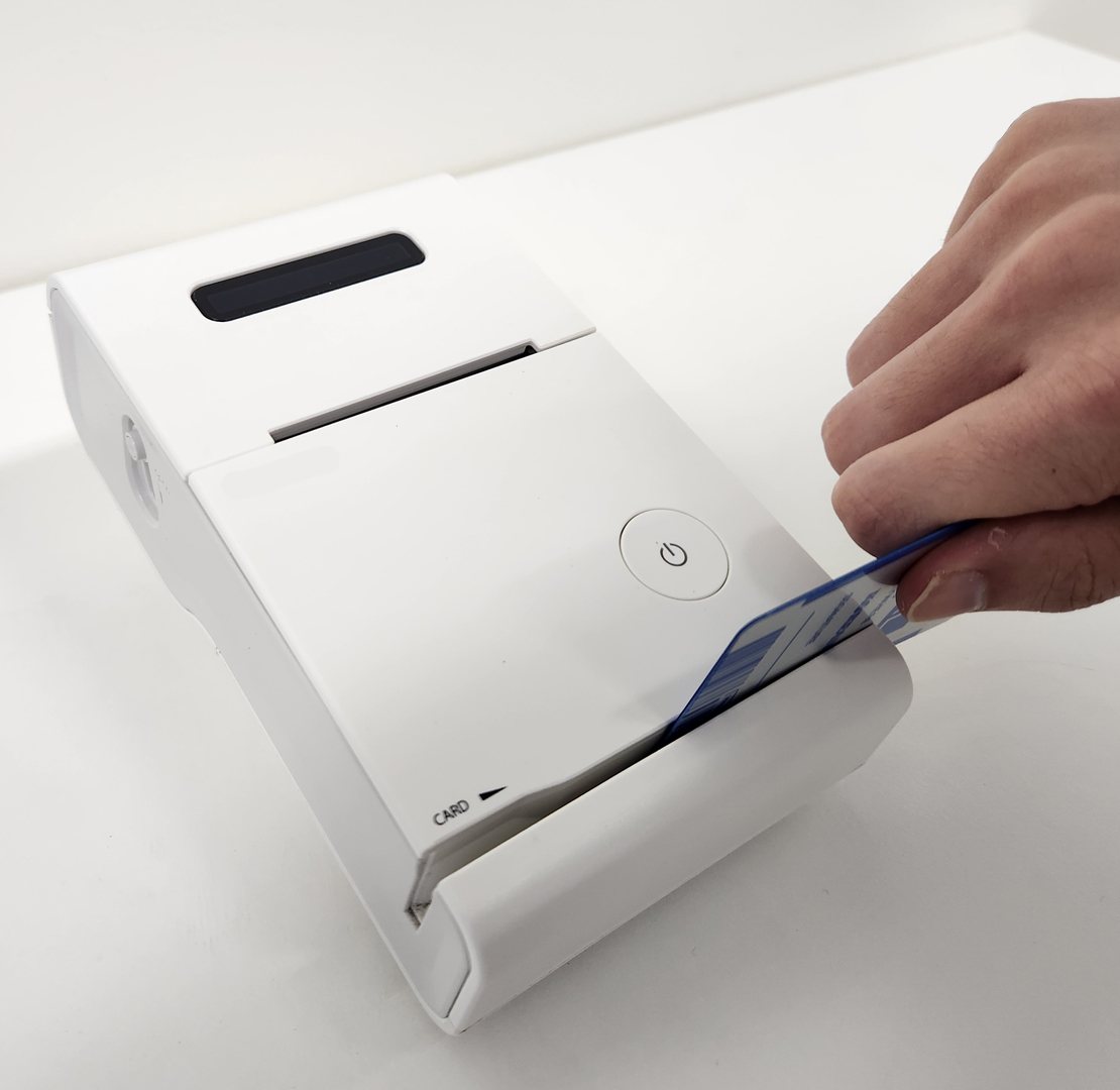 Taxi receipt printer reading a card through its built-in card reader